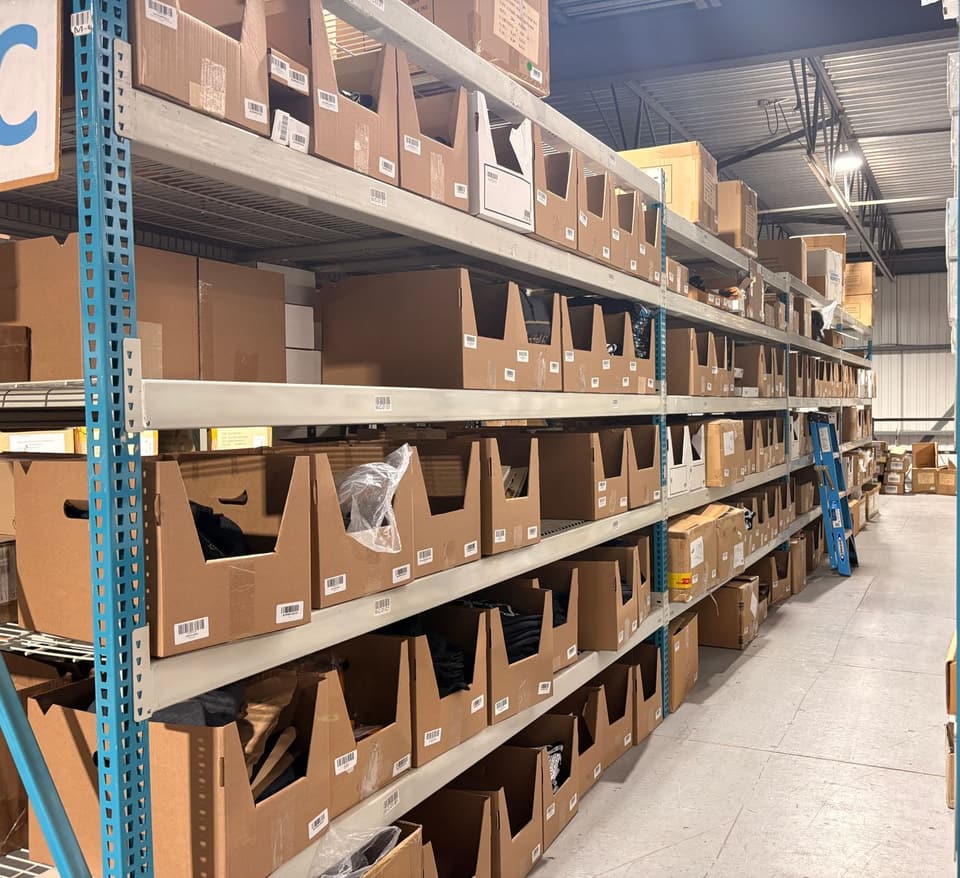 An aisle of bins, each with its location label