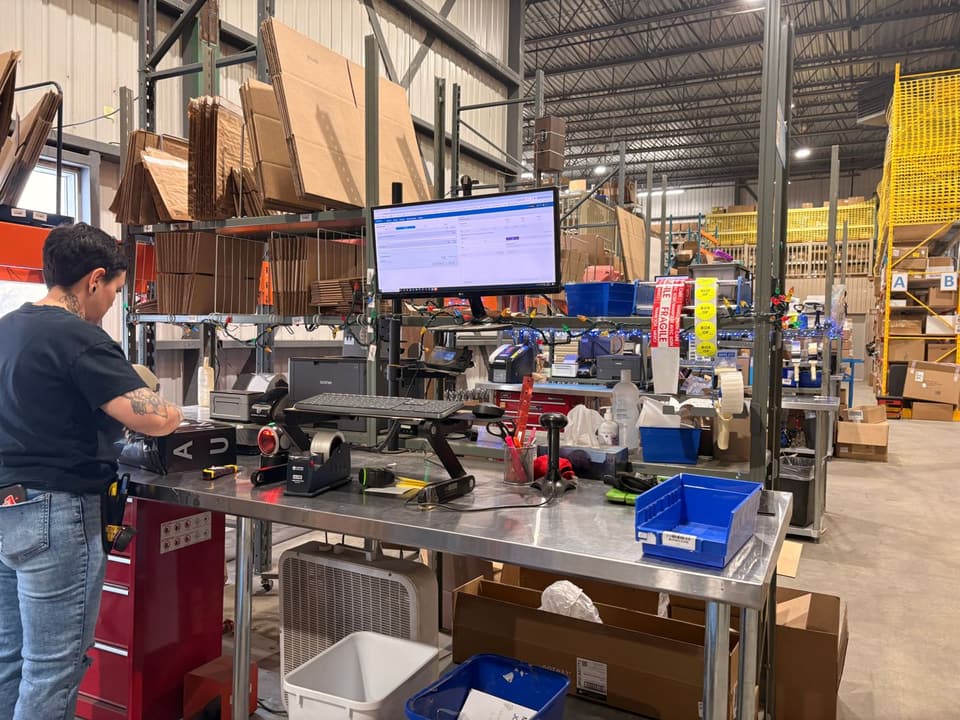 A packing station: screen, scale, label printer